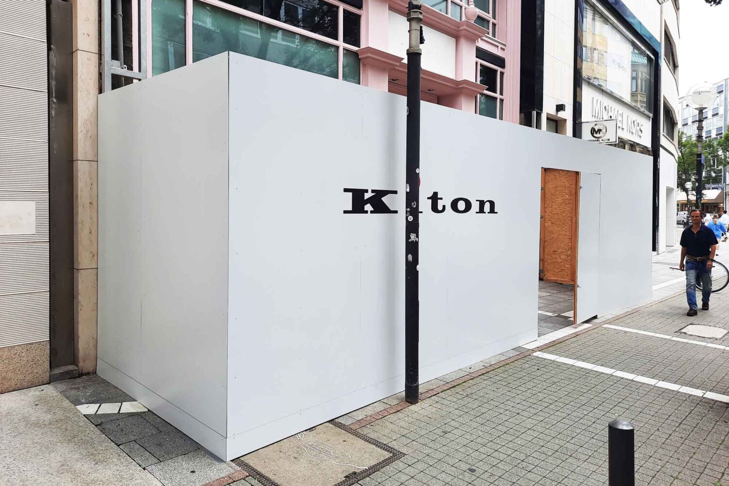 Bauzaun-mit-Verbundplatten-weiss2 Bauzaun aus Holzkonstruktion für Kiton auf der Goethestrasse in Frankfurt